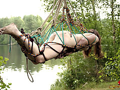 Outdoors Pictures -  Naughty girl in japanese bondage suspended on the tree